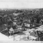 View from atop Gibraltar, looking down on the 200 block of 3rd Street. Note the horse & carriage!